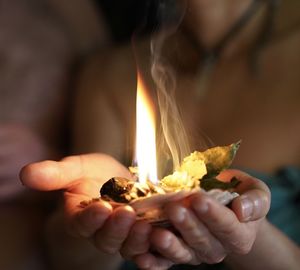 Close-up of hand holding candles