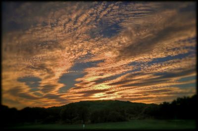 Scenic view of landscape against cloudy sky