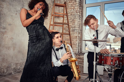 Rear view of young woman standing in workshop