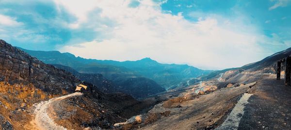 Panoramic view of mountains against cloudy sky