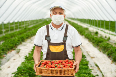 Man working in basket on field