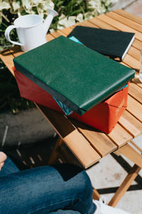 Low section of woman holding book