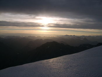 Scenic view of snowcapped mountains against sky during sunset