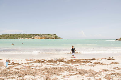 Man on beach against sky