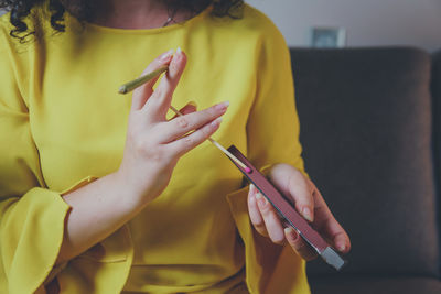 Midsection of woman using mobile phone