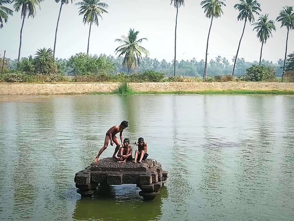 MEN SWIMMING IN LAKE