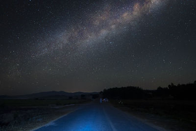 Scenic view of road against sky at night