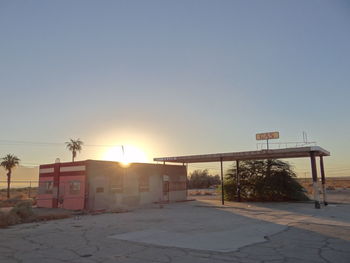 Empty road against sky during sunset