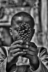 Close-up of hand holding acorn 