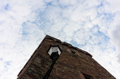 Low angle view of old building against cloudy sky