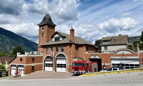 Building by street against sky in city
