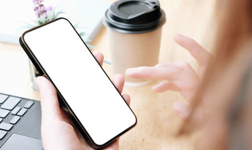 Close-up of hand holding mobile phone