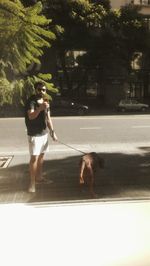 Full length of man standing on sidewalk