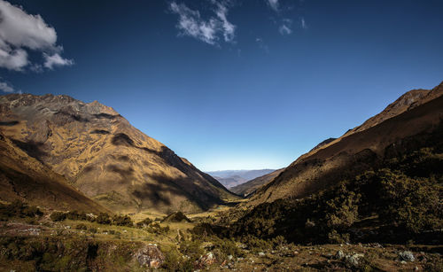 Scenic view of mountains against blue sky