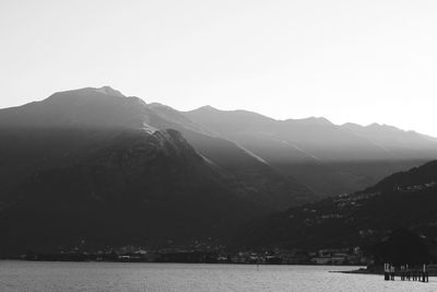 Scenic view of lake and mountains against clear sky