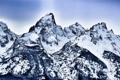 Close-up of snow on mountain against sky