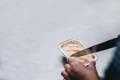 Cropped hands preparing food in kitchen