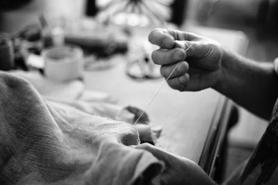 Cropped hand of tailor working in workshop