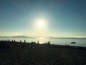 Scenic view of beach against clear sky during sunset