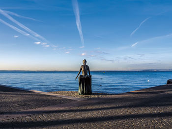 Man standing on beach against sky