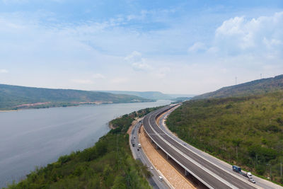 Road leading towards mountains against sky