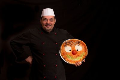 Portrait of chef holding cake