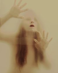 Close-up of woman touching condensed glass