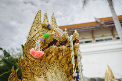 Close-up of buddha statue against building