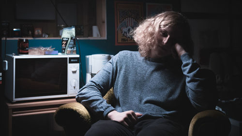 Man sitting on bed at home