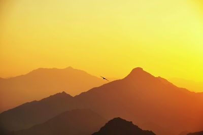 Scenic view of silhouette mountains against sky during sunset