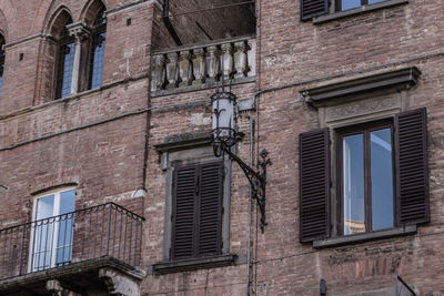 Low angle view of street light against building