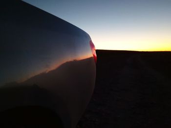 Close-up of mountain against clear sky at sunset