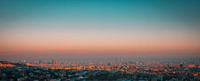 High angle shot of townscape against sky at dusk