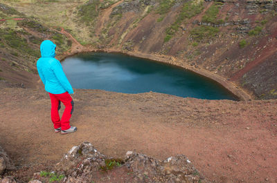 Traveler woman admiring kerid crater, iceland