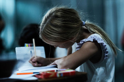 Portrait of little girl studying