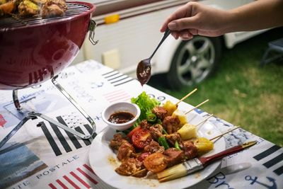 Midsection of person preparing food on table