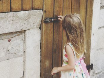 Girl closing door of house