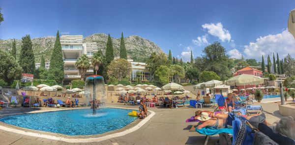 Tourists in front of building against clear sky