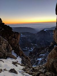 Scenic view of rocky mountains against sky during sunset