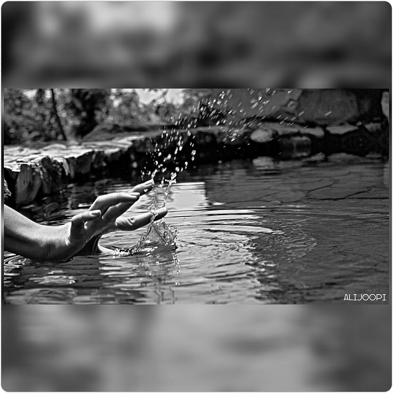 water, lifestyles, person, holding, focus on foreground, leisure activity, men, part of, selective focus, close-up, transfer print, unrecognizable person, reflection, auto post production filter, cropped, outdoors