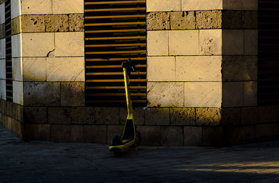 Yellow wall by sidewalk against building