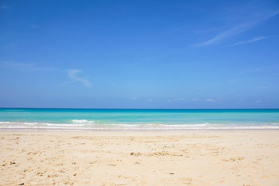 Scenic view of beach against blue sky