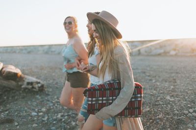 Full length of a smiling young woman standing on land