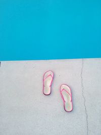 High angle view of flip-flop by swimming pool