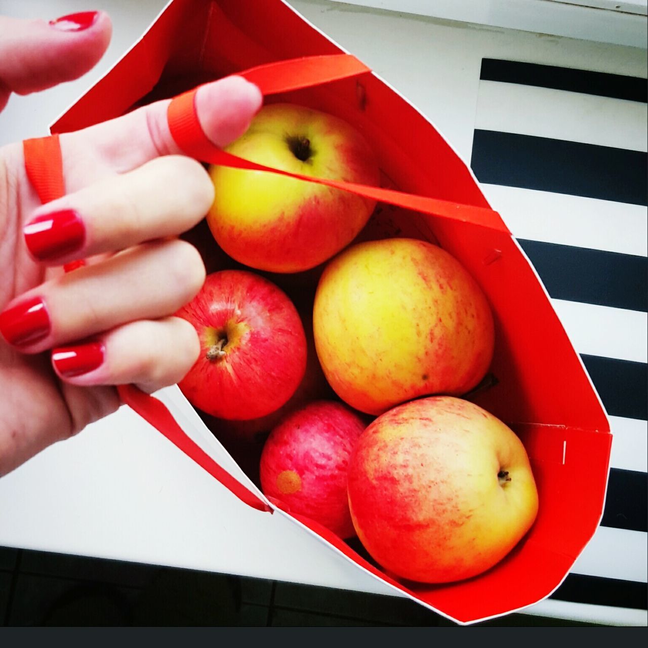 food and drink, food, person, holding, fruit, healthy eating, freshness, cropped, part of, lifestyles, red, unrecognizable person, indoors, human finger, leisure activity, apple - fruit, vegetable