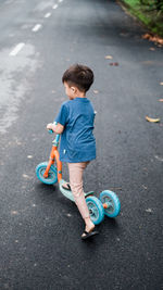 High angle view of boy playing with toy on road