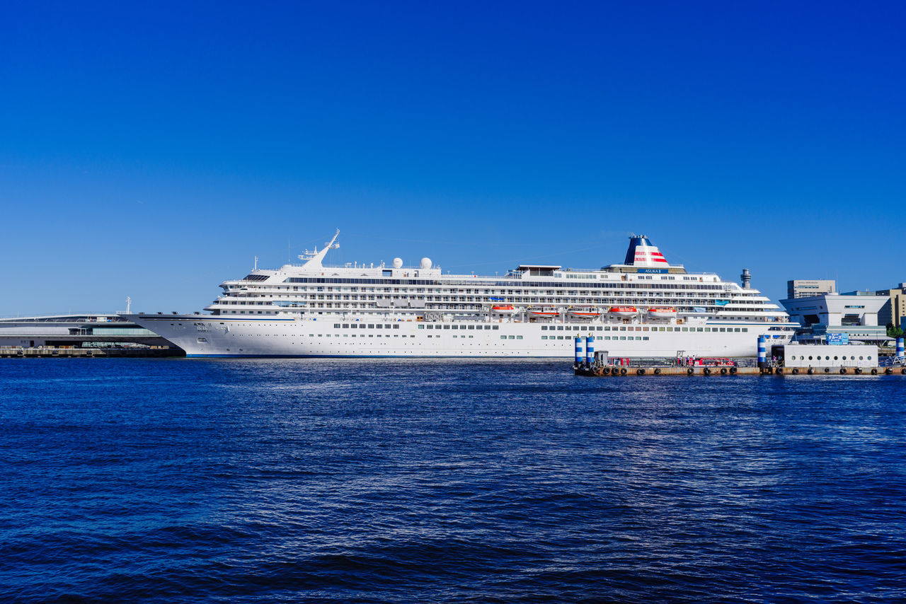 cruise ship, transportation, water, nautical vessel, passenger ship, vehicle, mode of transportation, ocean liner, sea, ship, blue, sky, motor ship, travel, architecture, cruise, nature, craft, freight transport, watercraft, travel destinations, clear sky, no people, channel, outdoors, ferry, built structure, city, luxury, sailing, day, harbor, business