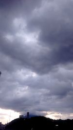 Low angle view of storm clouds over city