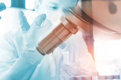 Close-up of male scientist analyzing chemical in laboratory