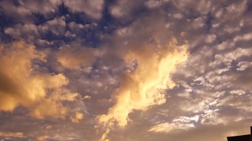 Low angle view of dramatic sky during sunset